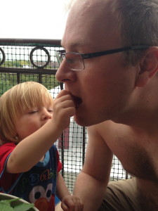 Sharing homegrown strawberries with Daddy.